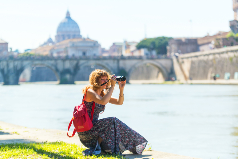 Young woman taking picture in Rome, Italy